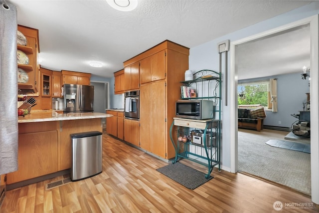 236 Newaukum Valley Rd, Chehalis, WA 98532 - kitchen with appliances with stainless steel finishes, open shelves, a peninsula, and brown cabinets