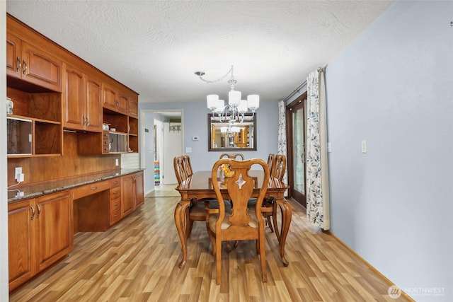 236 Newaukum Valley Rd, Chehalis, WA 98532 - dining room with a chandelier, light wood-style flooring, and a textured ceiling