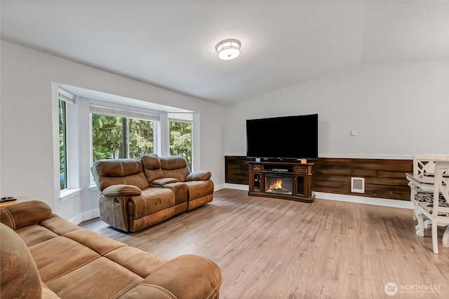 17642 Vine Ln SE, Yelm, WA 98597 - living room featuring lofted ceiling, light wood-style floors, and baseboards