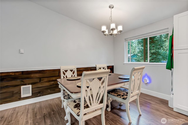 17642 Vine Ln SE, Yelm, WA 98597 - dining space featuring a chandelier, wood finished floors, and baseboards