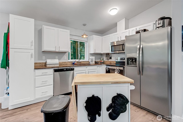 17642 Vine Ln SE, Yelm, WA 98597 - kitchen featuring appliances with stainless steel finishes, butcher block countertops, light wood-style flooring, white cabinetry, and vaulted ceiling
