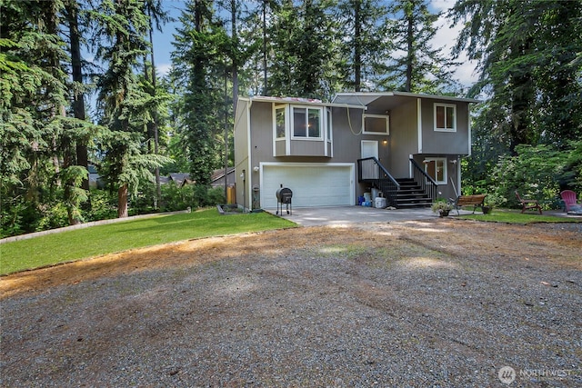 17642 Vine Ln SE, Yelm, WA 98597 - raised ranch with driveway, an attached garage, and a front yard