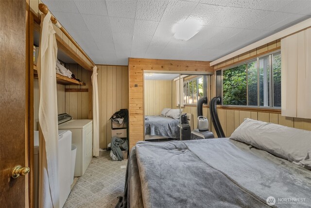 17924 E Clear Lake Blvd SE, Yelm, WA 98597 - bedroom featuring washer and dryer and wood walls