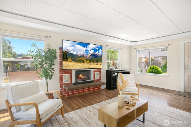 15222 37th Pl S, Tukwila, WA 98188 - living room with wood finished floors, a brick fireplace, and a drop ceiling