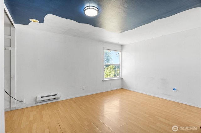 223 Carswell Dr, Moses Lake, WA 98837 - empty room featuring wood finished floors, baseboard heating, and baseboards