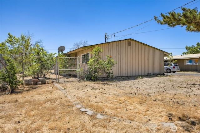 223 Carswell Dr, Moses Lake, WA 98837 - view of side of home featuring a gate and board and batten siding