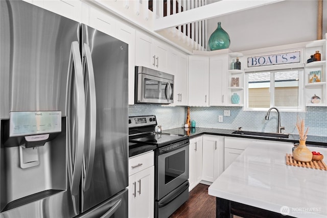 255 Lake Front Rd, Orondo, WA 98843 - kitchen featuring stainless steel appliances, open shelves, tasteful backsplash, and white cabinetry