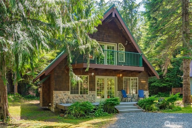 14030 Shuksan Rim Dr, Glacier, WA 98244 - view of front of house featuring stone siding and a balcony