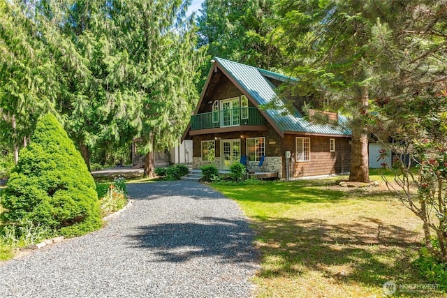 14030 Shuksan Rim Dr, Glacier, WA 98244 - view of front of house with a standing seam roof, a metal roof, driveway, a porch, and stone siding