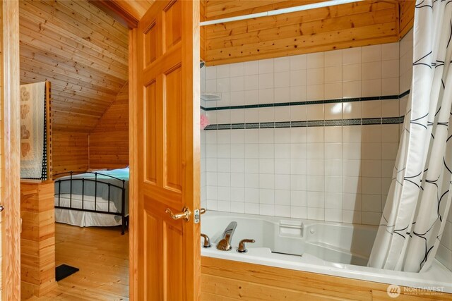 14030 Shuksan Rim Dr, Glacier, WA 98244 - bathroom with shower / tub combo, vaulted ceiling, and wood finished floors
