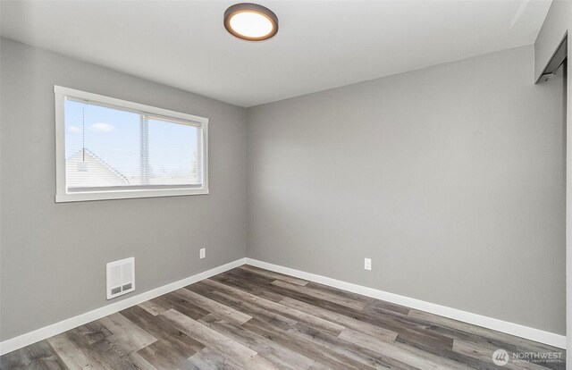 8805 11th St NE, Lake Stevens, WA 98258 - unfurnished room featuring baseboards and dark wood-style flooring