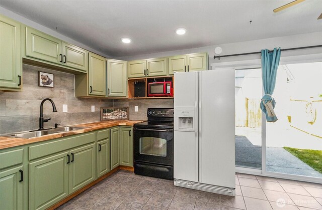 8805 11th St NE, Lake Stevens, WA 98258 - kitchen with white fridge with ice dispenser, black electric range, a sink, green cabinetry, and light tile patterned flooring