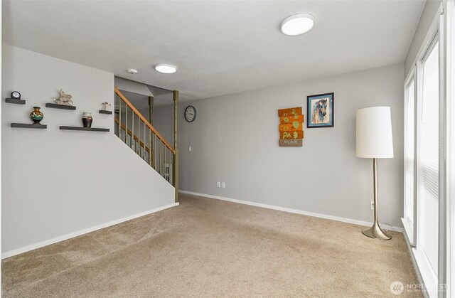8805 11th St NE, Lake Stevens, WA 98258 - unfurnished living room featuring stairway, carpet floors, and baseboards