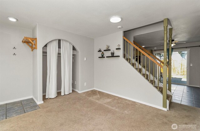8805 11th St NE, Lake Stevens, WA 98258 - empty room with carpet, arched walkways, stairs, a ceiling fan, and baseboards
