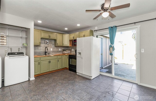 8805 11th St NE, Lake Stevens, WA 98258 - kitchen featuring white refrigerator with ice dispenser, washer / clothes dryer, black / electric stove, a sink, and green cabinets