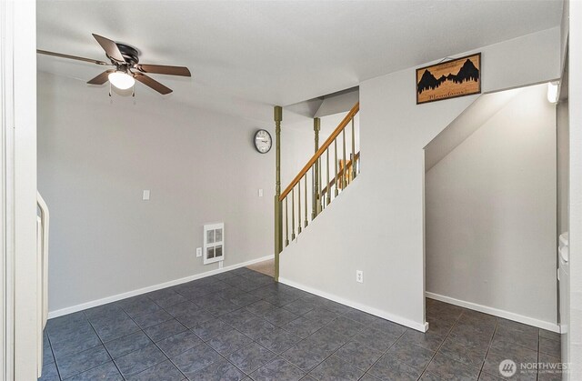 8805 11th St NE, Lake Stevens, WA 98258 - unfurnished living room featuring stairs, ceiling fan, dark tile patterned flooring, and baseboards