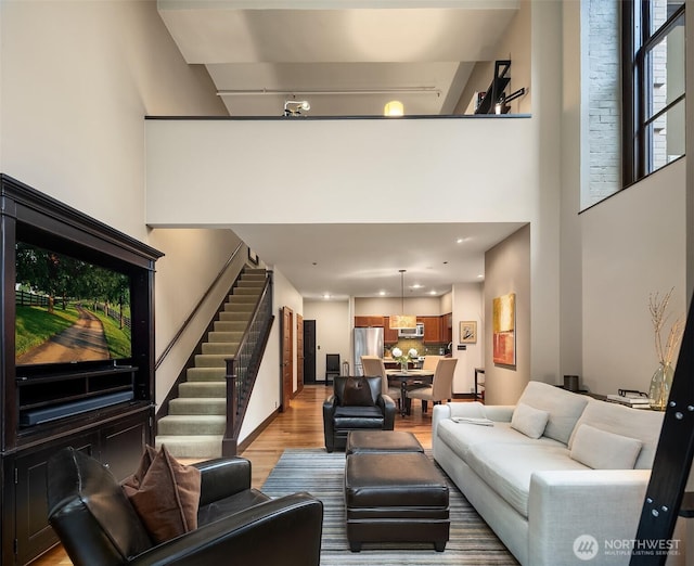 201 Galer St Unit 102, Seattle, WA 98109 - living area featuring light wood-style floors, stairway, a towering ceiling, and recessed lighting