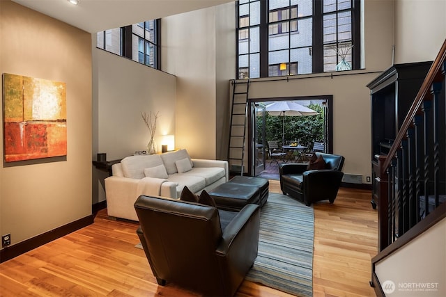 201 Galer St Unit 102, Seattle, WA 98109 - living area featuring wood finished floors, a high ceiling, stairs, and recessed lighting