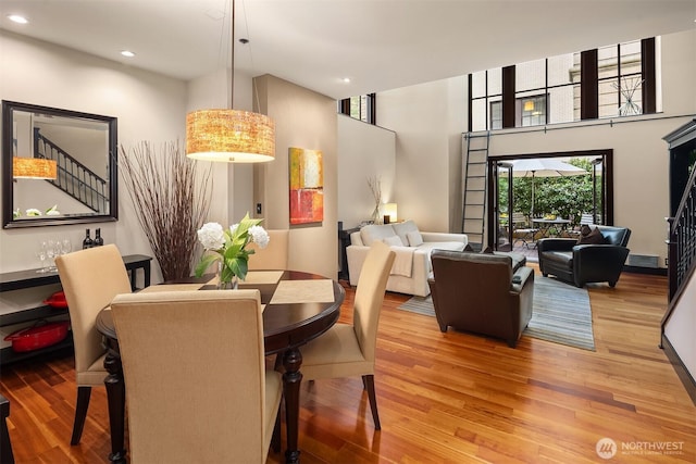 201 Galer St Unit 102, Seattle, WA 98109 - dining room featuring wood finished floors, recessed lighting, and a towering ceiling