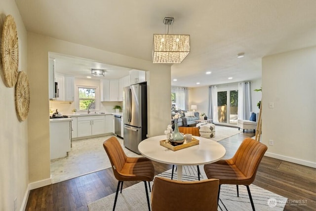6410 Cypress St, Everett, WA 98203 - dining room featuring light wood-style flooring, recessed lighting, and a chandelier