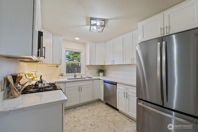 6410 Cypress St, Everett, WA 98203 - kitchen with appliances with stainless steel finishes, white cabinetry, light stone countertops, and a textured ceiling