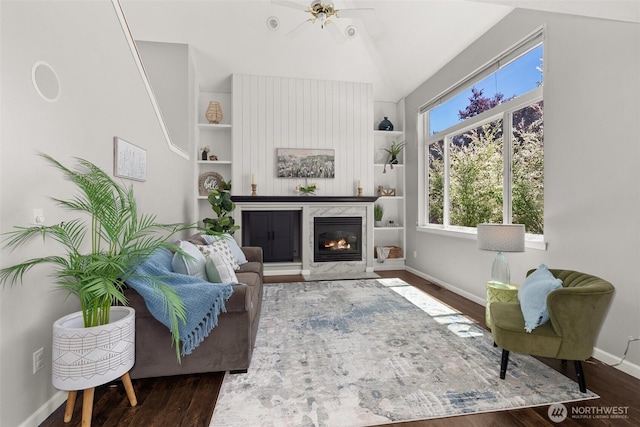 4109 Ingleside Loop SE, Lacey, WA 98503 - living room featuring vaulted ceiling, a fireplace, wood finished floors, built in features, and a ceiling fan