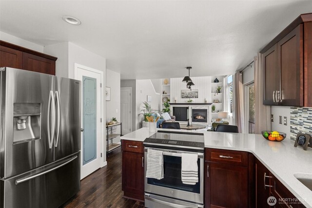 4109 Ingleside Loop SE, Lacey, WA 98503 - kitchen featuring stainless steel appliances, light countertops, dark wood finished floors, a peninsula, and open floor plan