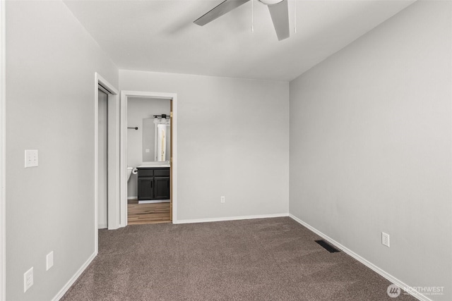 4109 Ingleside Loop SE, Lacey, WA 98503 - unfurnished bedroom with dark carpet, connected bathroom, and ceiling fan