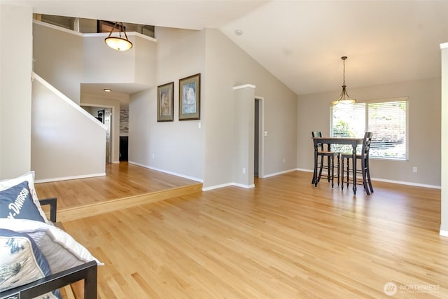 913 N Mountain View Ave, Tacoma, WA 98406 - living room featuring vaulted ceiling, light wood-type flooring, and stairway