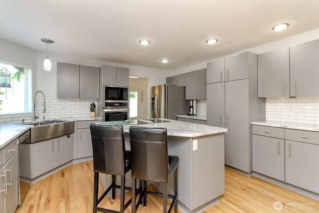 913 N Mountain View Ave, Tacoma, WA 98406 - kitchen featuring gray cabinetry, appliances with stainless steel finishes, tasteful backsplash, and recessed lighting