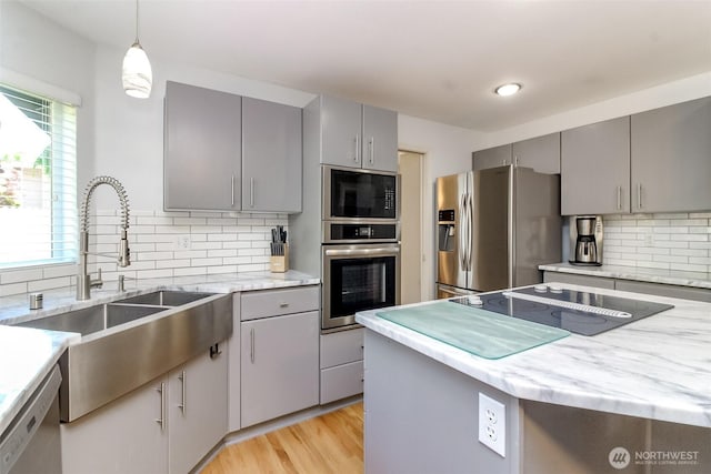 913 N Mountain View Ave, Tacoma, WA 98406 - kitchen featuring gray cabinetry, black appliances, decorative backsplash, and light wood finished floors