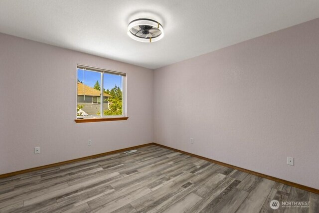 2004 15th Ave SW, Olympia, WA 98502 - empty room with wood finished floors and a ceiling fan