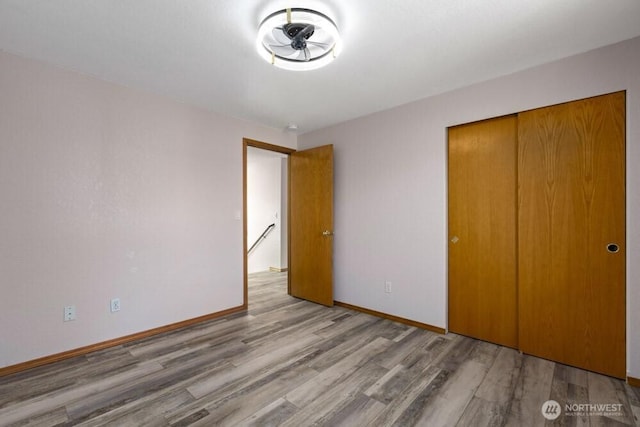 2004 15th Ave SW, Olympia, WA 98502 - unfurnished bedroom with wood finished floors and a closet