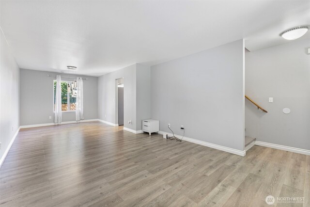 20602 86th Avenue Ct E, Spanaway, WA 98387 - unfurnished room featuring wood finished floors, stairway, and baseboards
