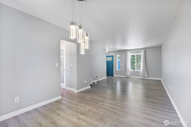 20602 86th Avenue Ct E, Spanaway, WA 98387 - unfurnished room featuring wood finished floors, baseboards, and a chandelier
