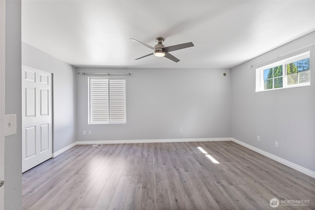 20602 86th Avenue Ct E, Spanaway, WA 98387 - spare room with a ceiling fan, wood finished floors, and baseboards