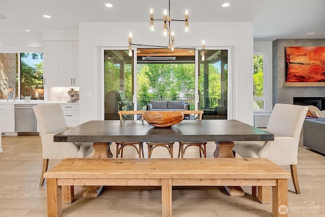14430 SE 18th St, Bellevue, WA 98007 - dining space with recessed lighting, light wood finished floors, a chandelier, and a fireplace