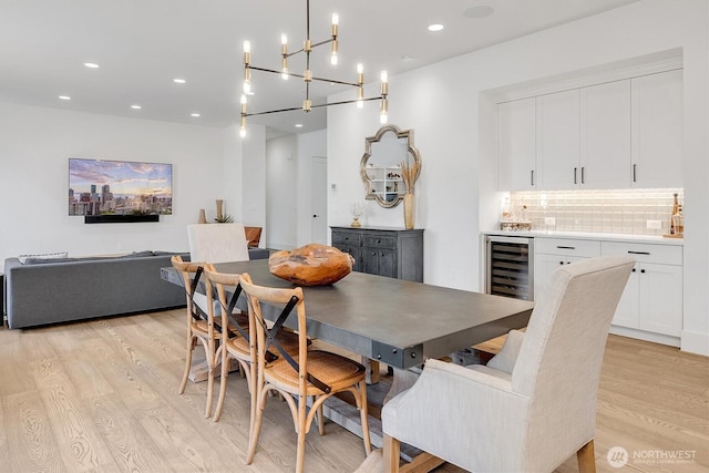 14430 SE 18th St, Bellevue, WA 98007 - dining area with light wood finished floors, beverage cooler, wet bar, a chandelier, and recessed lighting