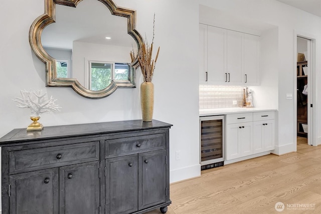 14430 SE 18th St, Bellevue, WA 98007 - indoor wet bar with wine cooler, light wood finished floors, baseboards, and recessed lighting