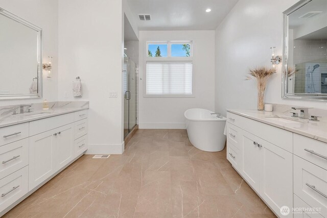 14430 SE 18th St, Bellevue, WA 98007 - full bathroom featuring two vanities, a stall shower, a soaking tub, baseboards, and recessed lighting