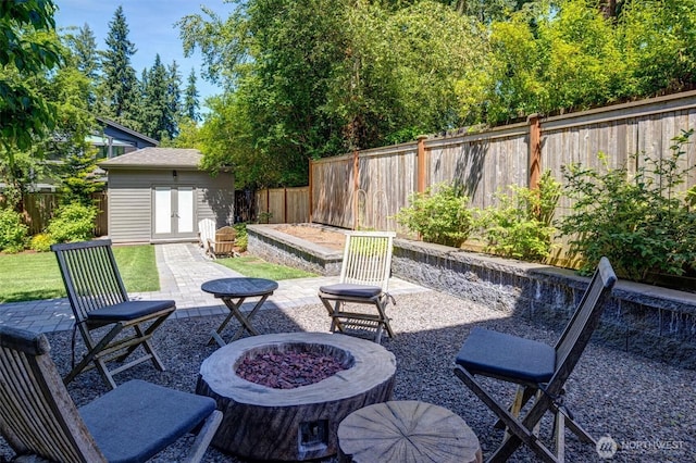 14430 SE 18th St, Bellevue, WA 98007 - fenced backyard with an outdoor fire pit, french doors, a patio area, and an outdoor structure