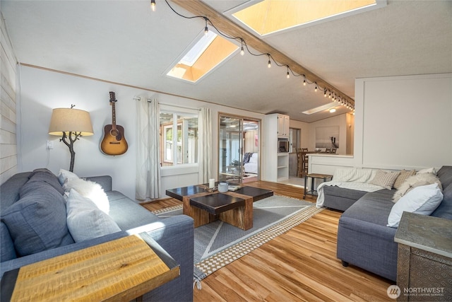 316 W Lake Samish Dr Unit 10, Bellingham, WA 98229 - living area with light wood finished floors, a skylight, and rail lighting