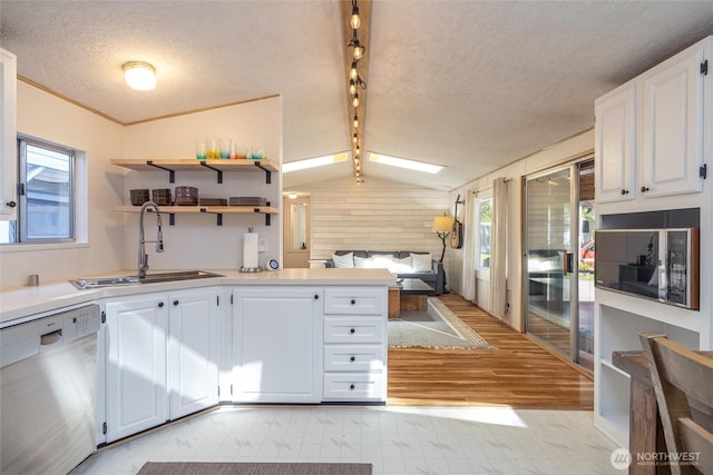 316 W Lake Samish Dr Unit 10, Bellingham, WA 98229 - kitchen with dishwasher, light flooring, a sink, a textured ceiling, and plenty of natural light