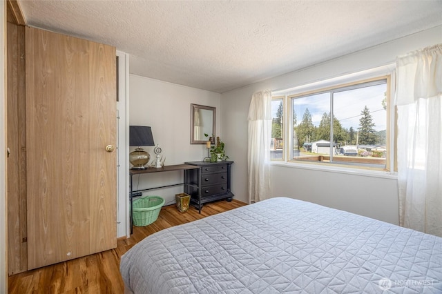 316 W Lake Samish Dr Unit 10, Bellingham, WA 98229 - bedroom featuring a textured ceiling and wood finished floors