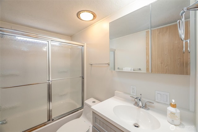 316 W Lake Samish Dr Unit 10, Bellingham, WA 98229 - bathroom with vanity, combined bath / shower with glass door, toilet, and a textured ceiling