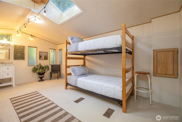 316 W Lake Samish Dr Unit 10, Bellingham, WA 98229 - bedroom with a skylight, lofted ceiling, a textured ceiling, and rail lighting