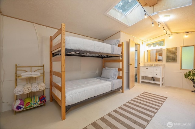 316 W Lake Samish Dr Unit 10, Bellingham, WA 98229 - carpeted bedroom featuring a skylight, track lighting, lofted ceiling, and a textured ceiling