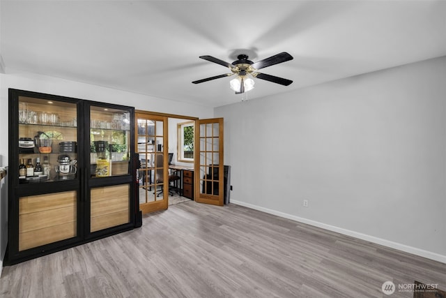 6218 199th Street Ct E, Spanaway, WA 98387 - empty room with wood finished floors, a ceiling fan, and french doors