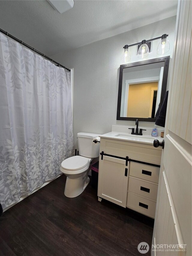 4776 Prairie Ln, Sedro Woolley, WA 98284 - full bathroom featuring wood finished floors, toilet, vanity, and a textured ceiling