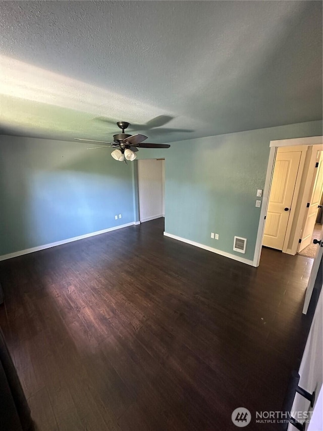 4776 Prairie Ln, Sedro Woolley, WA 98284 - spare room featuring dark wood-style floors, ceiling fan, baseboards, and a textured ceiling
